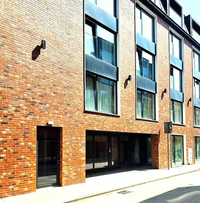 a red brick building with two entrances to a building at Royal Kątowa Apartment in Kraków