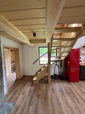 a large room with wooden stairs in a house at Ostoja Zawoja in Zawoja