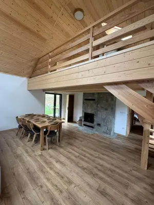 a large room with a table and a wooden ceiling at Ostoja Zawoja in Zawoja