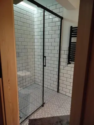 a shower with a glass door in a bathroom at Ostoja Zawoja in Zawoja