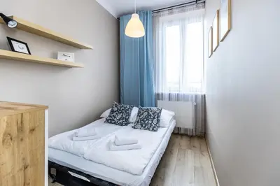 a small room with a bed and a window at Apartment next to Main Station Krakow in Kraków