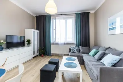 a living room with a couch and a tv at Apartment next to Main Station Krakow in Kraków