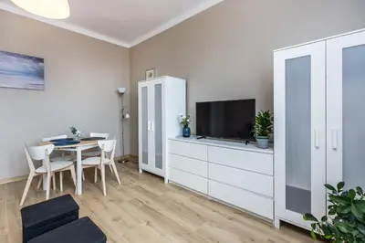 a living room with a table and a tv at Apartment next to Main Station Krakow in Kraków