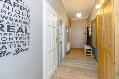 a hallway with a wall with writing on it at Apartment next to Main Station Krakow in Kraków