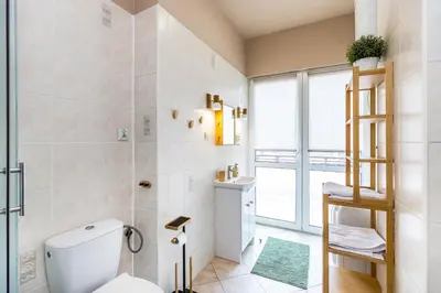 a bathroom with a toilet and a ladder in it at Apartment next to Main Station Krakow in Kraków