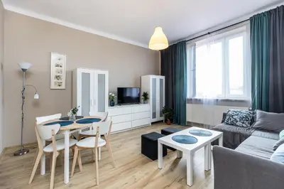 a living room with a couch and a table and chairs at Apartment next to Main Station Krakow in Kraków
