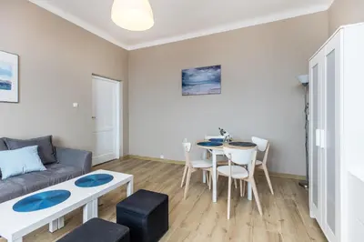 a living room with a couch and a table at Apartment next to Main Station Krakow in Kraków