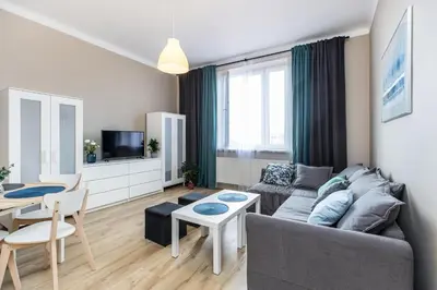 a living room with a couch and a table at Apartment next to Main Station Krakow in Kraków
