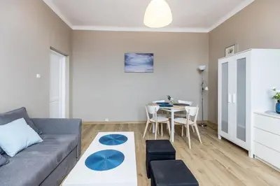 a living room with a couch and a table at Apartment next to Main Station Krakow in Kraków
