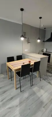a dining room table and chairs in a room at Apartament Kraków Łobzów in Kraków