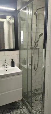 a bathroom with a glass shower and a sink at Apartament Kraków Łobzów in Kraków