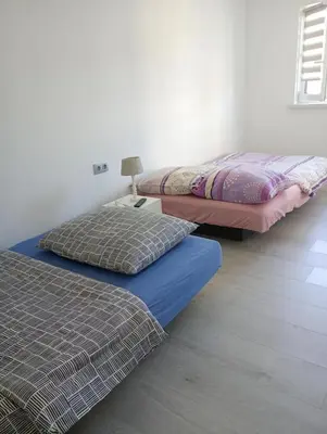 two beds sitting next to each other in a room at Agroturystyka u Pauliny in Sąspów
