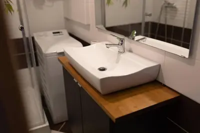 a bathroom with a white sink and a mirror at Studio Lublańska - przytulne, nowoczesne, w klimacie Krakowa in Kraków