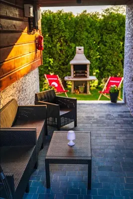 a patio with chairs and a table and a gazebo at Domek nad Jeziorem Siamoszyce in Siamoszyce