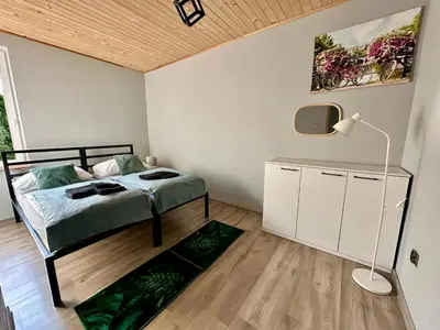 a bedroom with a bed and a lamp and a rug at Domek nad Jeziorem Siamoszyce in Siamoszyce