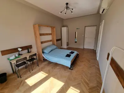a bedroom with a bed and a table and a desk at Fantastic-Inn Kraków - KR6 in Kraków