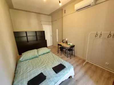 a bedroom with a bed and a table with a desk at Fantastic-Inn Kraków - KR6 in Kraków