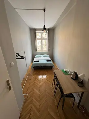 a room with a bed and a table and a window at Fantastic-Inn Kraków - KR6 in Kraków
