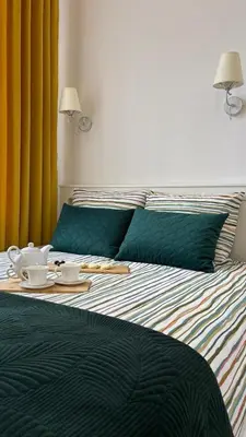 a bed with a tray of food on top of it at Golden Age Apartment Cracow in Kraków