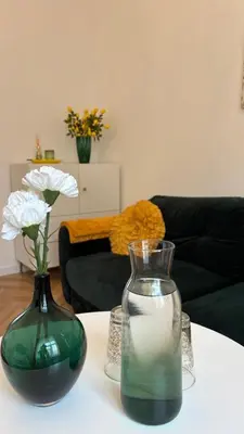 two vases sitting on a table in a living room at Golden Age Apartment Cracow in Kraków