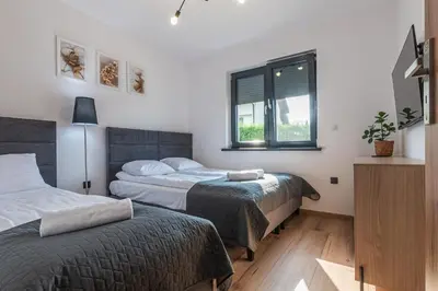 a bedroom with two beds and a window at Domek z Widokiem in Zator