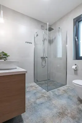 a bathroom with a shower with a sink and a toilet at Domek z Widokiem in Zator