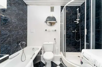a bathroom with a tub and a toilet and a shower at Osiedle Oświecenia Comfort Apartment by BookingHost in Kraków