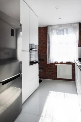 a kitchen with white cabinets and a window at Beautiful Apartment Avia with balcony in Cracow city in Kraków