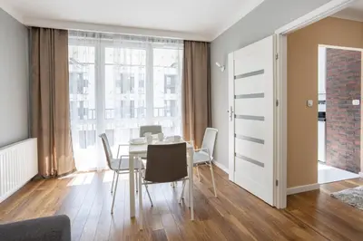a dining room with a table and chairs at Beautiful Apartment Avia with balcony in Cracow city in Kraków