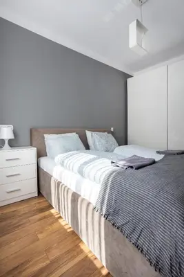 a white bedroom with a large bed and a dresser at Beautiful Apartment Avia with balcony in Cracow city in Kraków