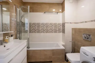 a bathroom with a tub and a sink and a toilet at Beautiful Apartment Avia with balcony in Cracow city in Kraków