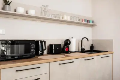 a kitchen counter with a microwave and a sink at City of the Kings - Corner 12 in Kraków