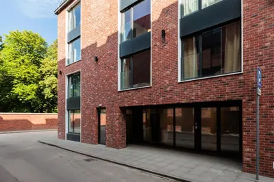 a red brick building with its doors open at City of the Kings - Corner 12 in Kraków