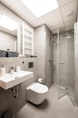 a bathroom with a toilet and a sink and a shower at City of the Kings - Corner 12 in Kraków
