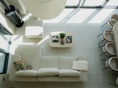 a living room with a white couch and a window at Babiogórska Stodoła in Zawoja