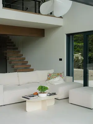 a living room with a white couch and a table at Babiogórska Stodoła in Zawoja
