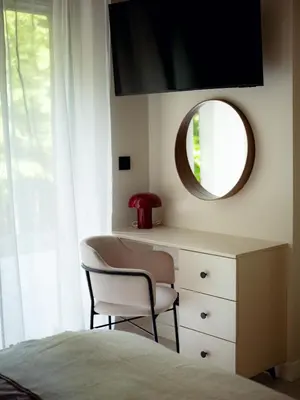 a bedroom with a desk and a mirror and a bed at Babiogórska Stodoła in Zawoja