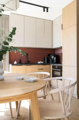 a kitchen with a wooden table and chairs at Osada Tabaszowa in Tabaszowa