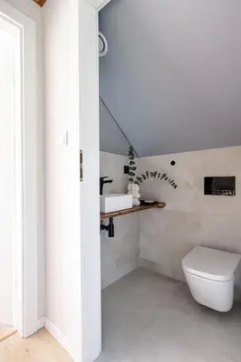a bathroom with a white toilet and a sink at Osada Tabaszowa in Tabaszowa