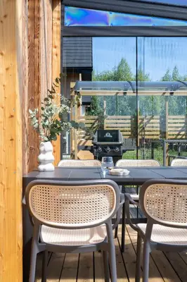 a patio with tables and chairs and a grill at Osada Tabaszowa in Tabaszowa