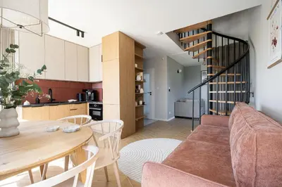 a living room and kitchen with a couch and a table at Osada Tabaszowa in Tabaszowa