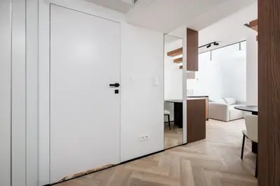 a room with white walls and a sliding door at City of the Kings-Riverside K22M52 in Kraków