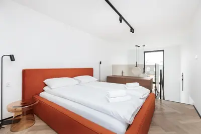 a bedroom with a large bed with white sheets at City of the Kings-Riverside K22M52 in Kraków