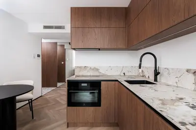 a kitchen with wooden cabinets and a counter top at City of the Kings-Riverside K22M52 in Kraków