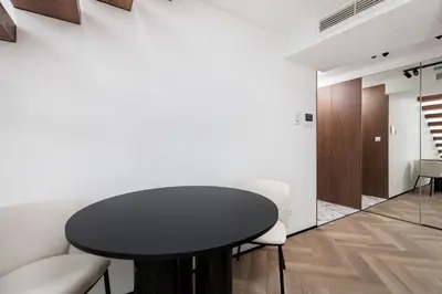 a dining room with a black table and white chairs at City of the Kings-Riverside K22M52 in Kraków