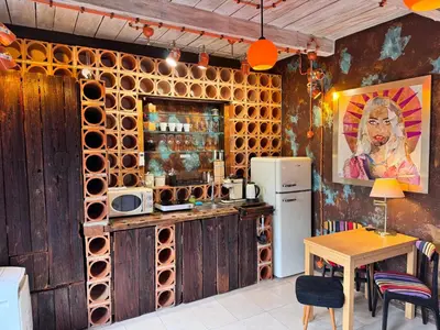 a kitchen with a table and a refrigerator at Noble Apartment & Sauna ZONE in Zabierzów