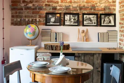 a room with a table with plates on it at Noble Apartment & Sauna ZONE in Zabierzów