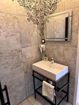 a bathroom with a sink and a mirror at Noble Apartment & Sauna ZONE in Zabierzów