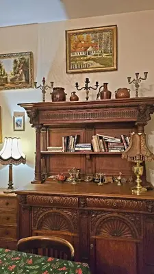 a large wooden table with a shelf of books at ATELIER Kazimierz in Kraków