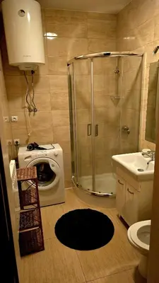 a bathroom with a shower and a washing machine at ATELIER Kazimierz in Kraków